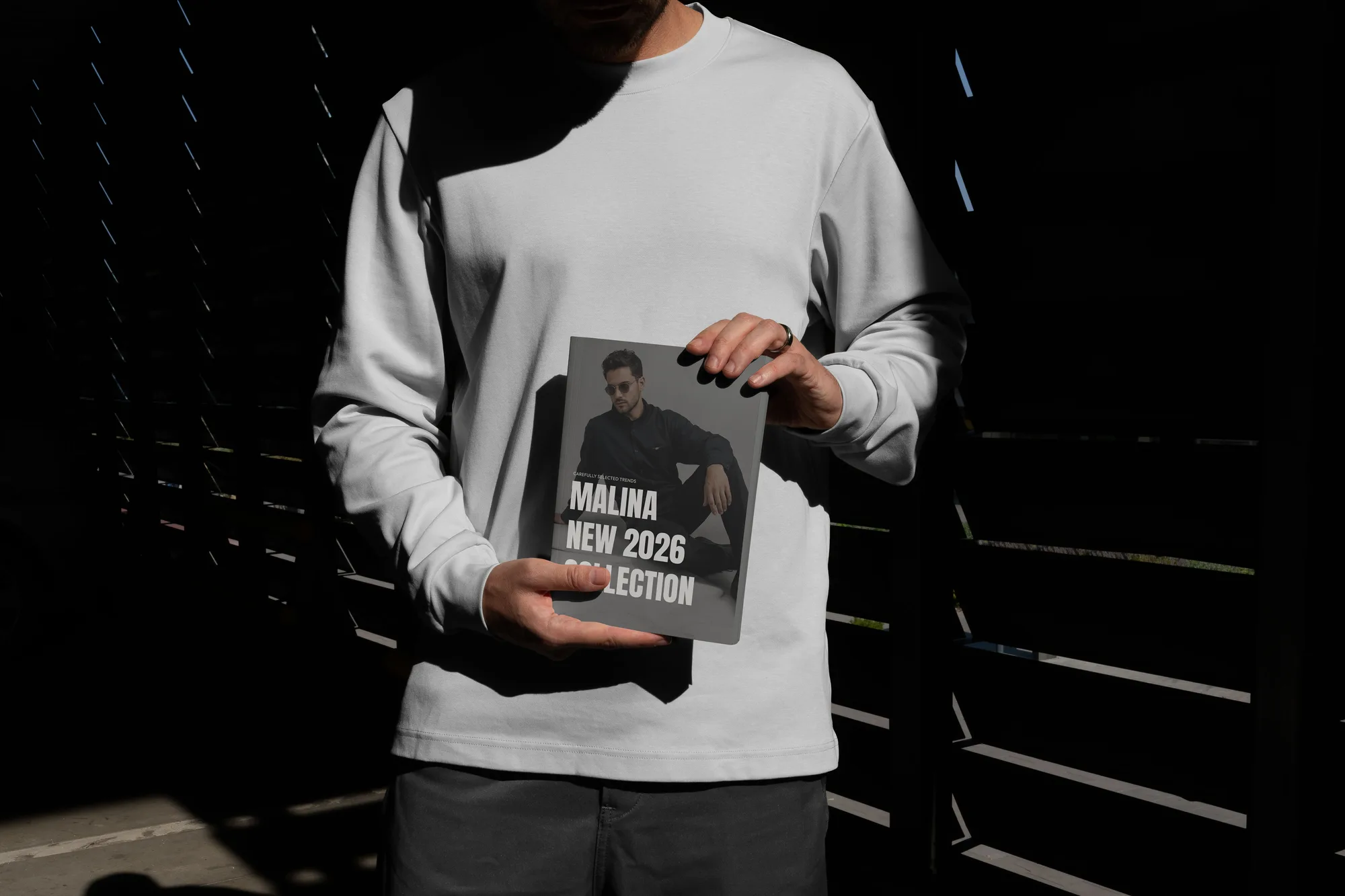 Malina New 2026 Collection lookbook, held against a sunlit sweatshirt